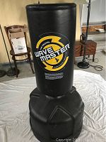 Front view of the Wavemaster punching bag with logo visible and base in foreground