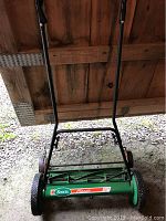 Full view of Scotts Classic 20 inch reel mower with green body and black handle showing overall condition.