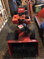 Front view of red Toro 824 snowblower showing auger and body