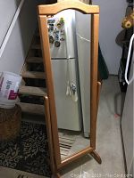 Front view of the full length mirror showing oak wood frame and clear reflective surface.