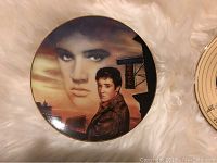 Plate showing image of Elvis Presley with Heartbreak Hotel sign in warm tones