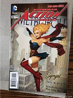 Photo of Action Comics #32 with Supergirl on cover, showing front cover details
