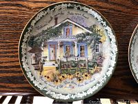 Photo of Bradford Exchange collector plate 'Warm Winter Welcomes' from Welcome Home series, plate 5, showing house painting with decorative floral green border and text