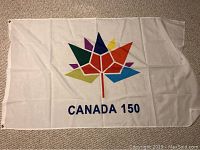 Canada 150 flag, white with multicolored maple leaf design