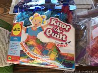 Photo of the Knot A Quilt kit packaging, shows branding, product size, and design
