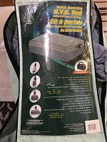 Front view of the packaged Woods Deluxe Queen Size B.Y.O. Bed with image showing the bed with mattress on frame and wheeled carrying case.