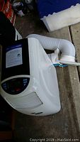 Top side view of the portable air conditioner/showing exhaust hose attachment
