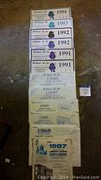 Photo showing many Whitman Liberty Album Supplement pages from 1987 to 1991 arranged in a row on floor.
