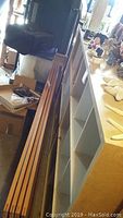 Photo of large wooden storage unit frame with multiple cubby holes and worn surfaces.