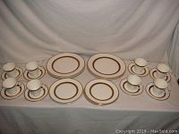Full set layout showing cups, saucers, dinner plates, and salad plates arranged on a cloth background.