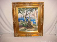 Front view of original framed landscape painting depicting trees and ocean