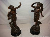 Two full-view figurines side by side on white backdrop