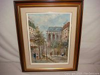 Full view of the framed oil painting showing the street scene and buildings