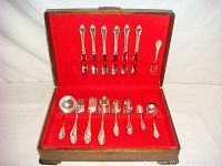 Full set arranged inside red velvet-lined wooden case showing the 43 pieces in Rogers 1847 Remembrance pattern.