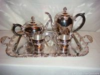 Full view of the 5-piece silver-plated coffee set on the ornate tray showing all pieces including coffee pot, teapot, sugar bowl, creamer, and tray.