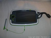 LeapPad Platinum kids tablet front view showing screen, joystick, button, and attached stylus with charging cable.