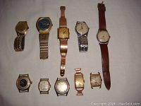 Overview of 10 vintage men's mechanical watches arranged on a white surface showing diversity of designs and strap materials, including metal and leather bands.