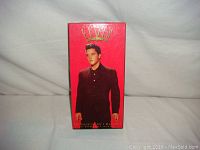 Original box with red background and Elvis in black suit on front, titled 'Elvis The Essential Elvis Presley 5 CD Set'.