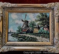 Full view of oil painting in ornate gilded frame showing landscape with windmill and countryside.