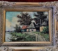 Front view of the original oil painting showing detail of cottages and waterway in carved gilded wooden frame.