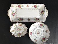 Three-piece Royal Albert Petit Point set: rectangular serving tray with handles, round saucer, and sweet meat dish arranged on black background