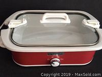 Front view of red Crock-Pot slow cooker with glass lid and control knob.