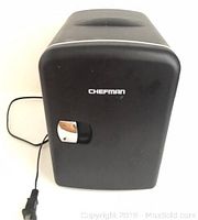 Front view of black Chefman personal mini fridge with power cord visible