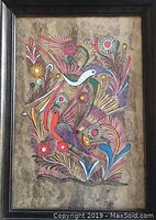Full view of the framed Mexican bark art showing intricate multicolored bird and floral motifs in a dark wooden frame.