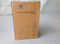 Front view of IDENTIGHT Portable Garment Steamer TW-7010 box, shows product outline drawing and model number