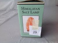 Closed box of Himalayan salt lamp showing product name and partial image of the lamp.