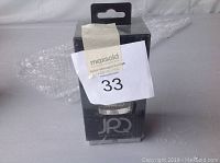 Front of boxed JPO-002 Bluetooth speaker showing clear packaging with product and branding visible