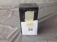 Photo of the front side of the PnBB JPQ-002 Bluetooth speaker boxed packaging with auction label