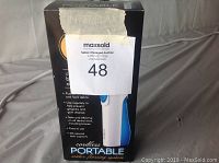 Box front showing image of cordless portable water flossing system with seller auction label.