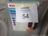 Box of CVS Health Portable Pulse Oximeter showing usage features and front design with product image.