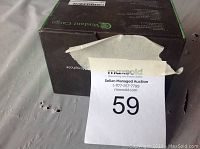 Top side of the sealed box with some damage to the packaging but label is present