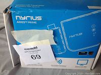 Blue and white Nyrius Aries Prime Wireless HD Transmitter box showing product branding and features.