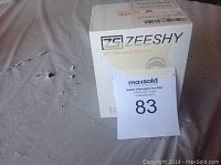 Photo of ZEESHY GPS Personal Tracker K9 showing front of box with branding and model info.