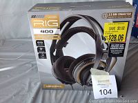 Boxed Plantronics Universal RIG 400 headset showing front of packaging including branding, product image, and information about 3.5 mm connector and surround sound.