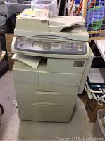 Front view of Samsung SCX-6345N printer fax machine showing control panel, paper trays, and automatic document feeder.