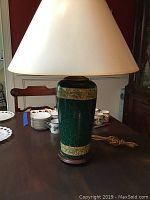 Full view of table lamp assembled with lampshade, showing lamp shape, color and texture.