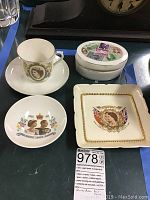 All four British memorabilia items on a tray including teacup set, trinket box, two decorative plates