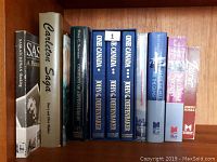 Photo showing 10 books related to Canadian history arranged side by side to show the spines.