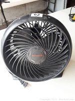 Photo of a black Honeywell table fan with spiral blade and grille design, showing front and power cord.
