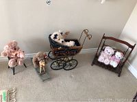 Overall lot showing five stuffed animals and wooden accessories including chair, rocking horse, carriage, and cradle.