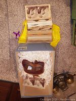 Photo showing stereoscope viewer inside a box with a large stack of stereoscopic cards above it