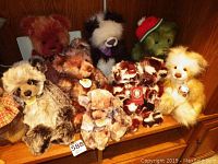 Wide shot of nine teddy bears on wooden cabinet
