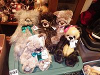 Five bears arranged on green plastic bin, full lot view