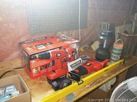 Black & Decker cordless power tools with box, level visible on table