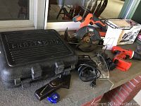 Photo showing Craftsman tool case, Black & Decker circular saw, drill, safety goggles, leather sheath, measuring tape