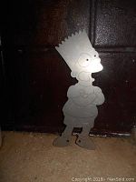 Front view of metal Bart Simpson cut out figure showing etched details